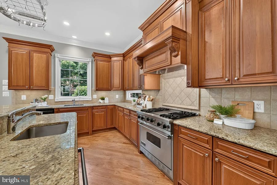 Cherry cabinet kitchen with a professional gas range